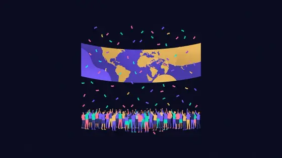 Crowd gathered under a stage banner with confetti and a globe